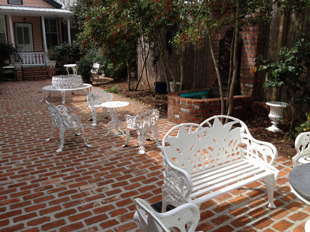Courtyard seating area with iron chairs and fountain