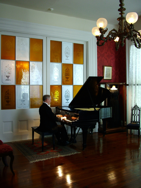 Pianist at the grand piano in the Antebellum Music Room